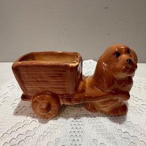 Vintage ceramic Cocker Spaniel dog planter featuring a dog pulling a wagon.